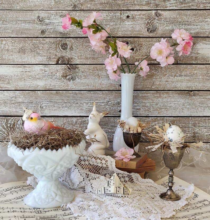 White Vase Filled with Nest and Bird Wearing a Paper Hat