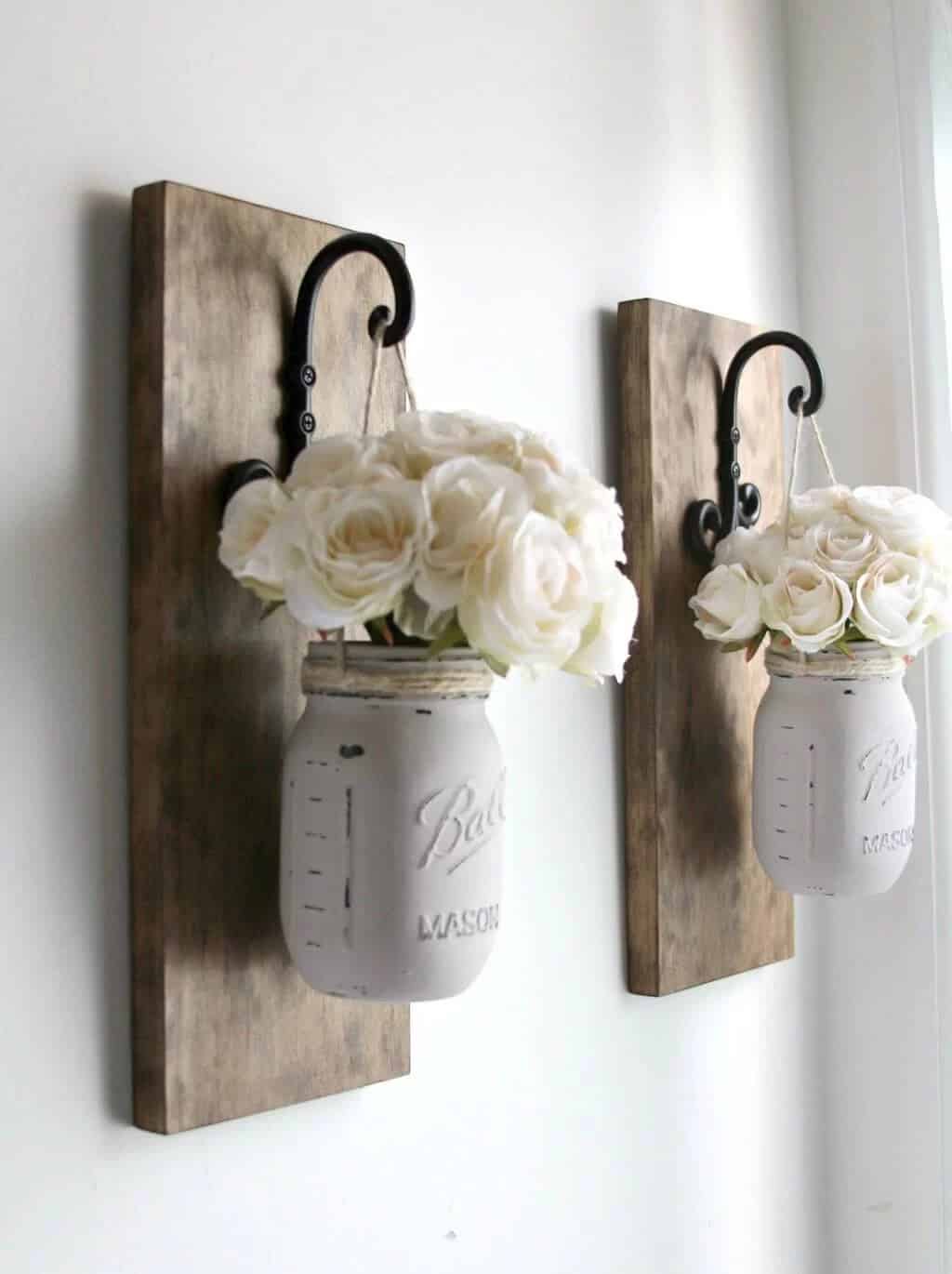 White Mason Jars Hung From Wall Hooks