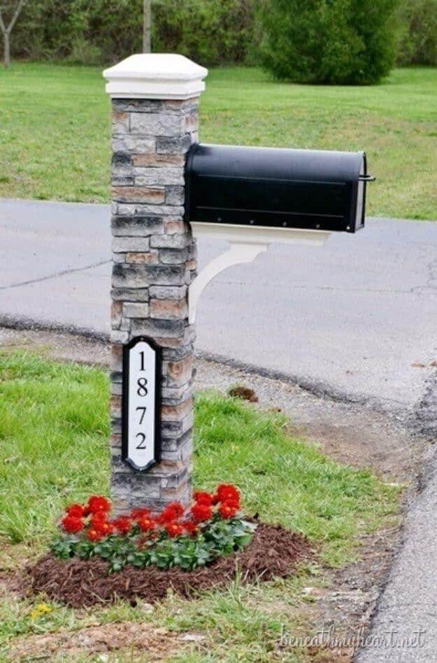 Stone Mailbox Post with a Red Flowerbed