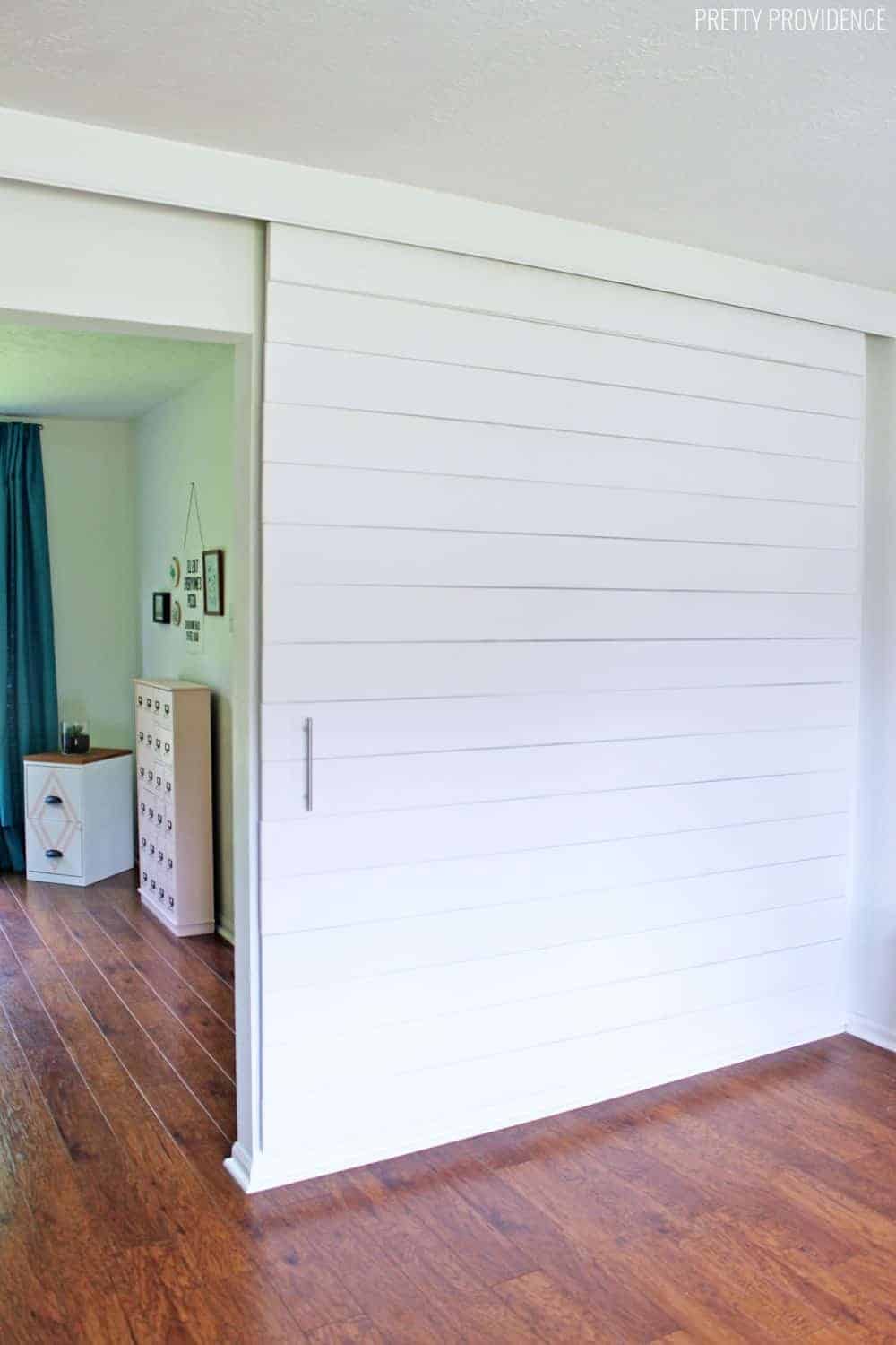 DIY Room Divider: Sliding White Shiplap Barn Door Divider Wall